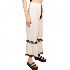 Pantaloni albi cu ciucuri negri